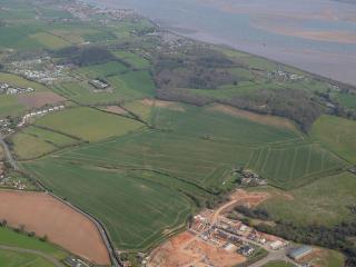 An aerial photo of green fields next to the Exe Estuary which will become Dawlish Countryside Park