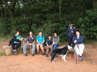 Group of dog walkers sat on bench